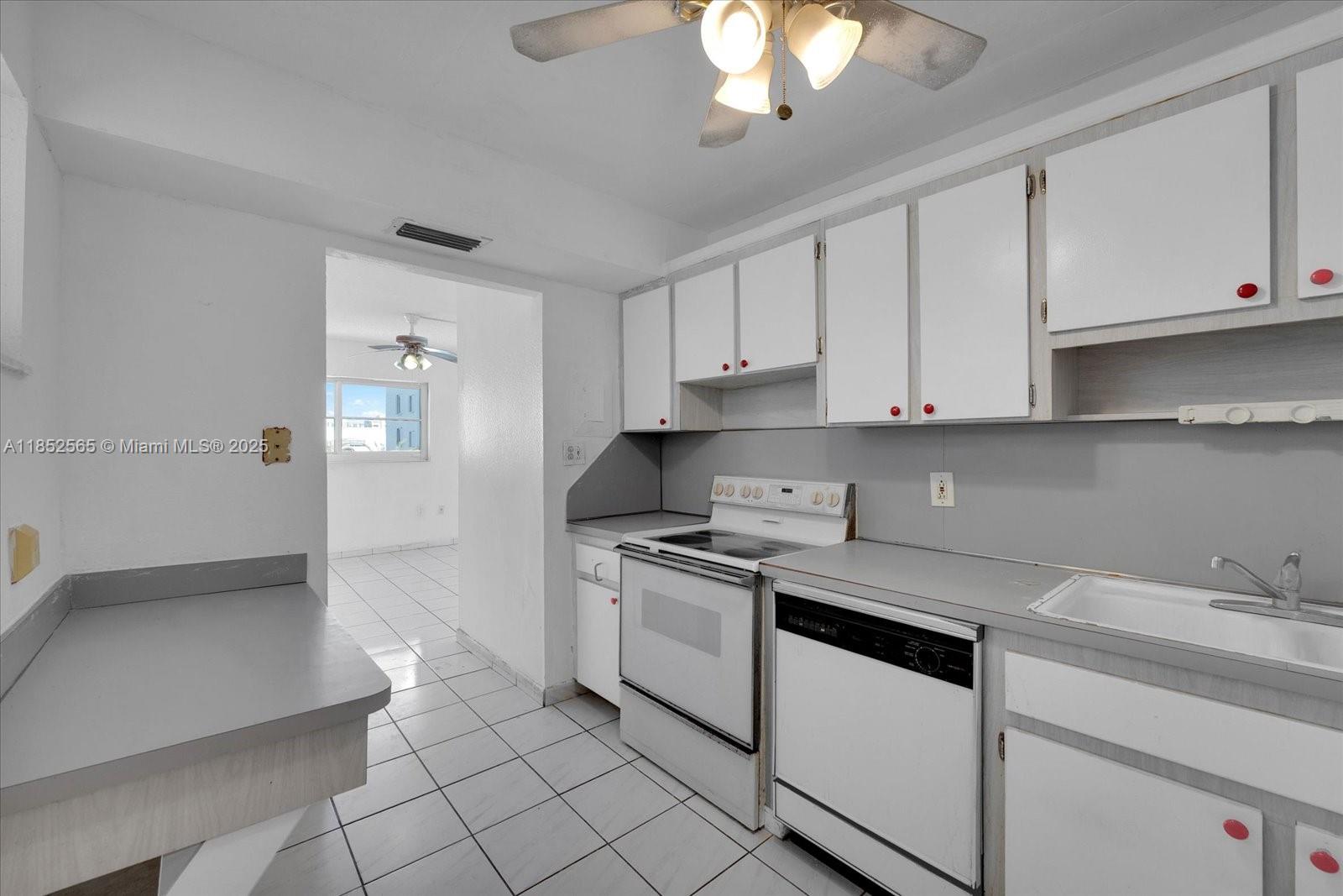 1750 James Avenue, Unit 7L Miami Beach, FL 33139 - Photo 7 of 27 a kitchen with stainless steel appliances granite countertop a sink and a stove