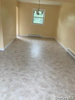 1455 East Forks Road Bay Shore, NY 11706 - Photo 3 of 7 an empty room with a window