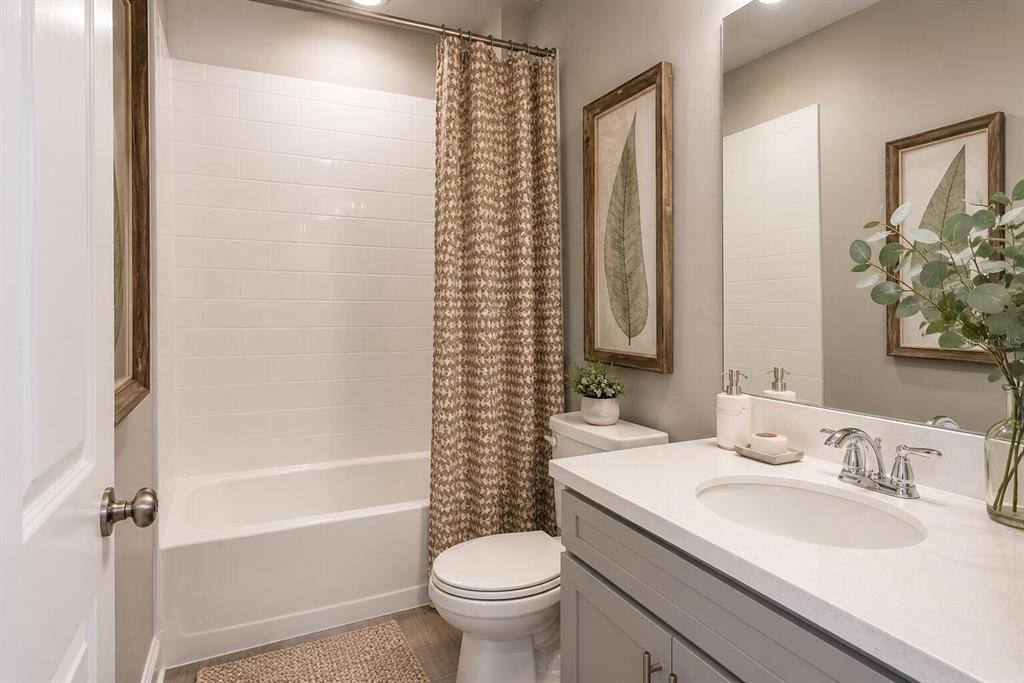 33320 Castaway Loop Wesley Chapel, FL 33543 - Photo 15 of 23 a bathroom with a granite countertop sink toilet and shower