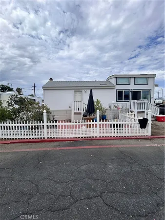a front view of a house with a yard and table and chairs