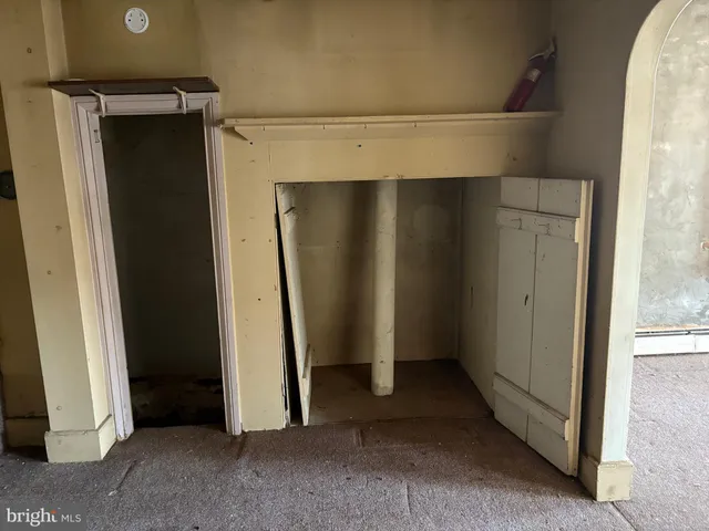 a view of staircase with white walls and a window