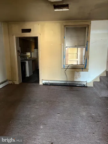 a kitchen with a refrigerator and a stove top oven