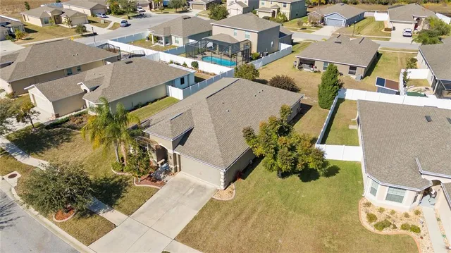 an aerial view of residential houses with outdoor space