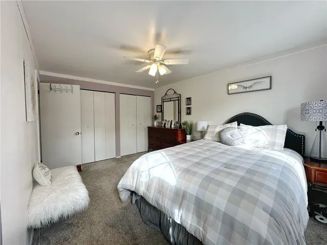 a spacious bedroom with a bed and a chandelier