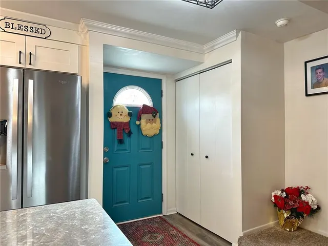 a view of a hallway to a livingroom with a workspace