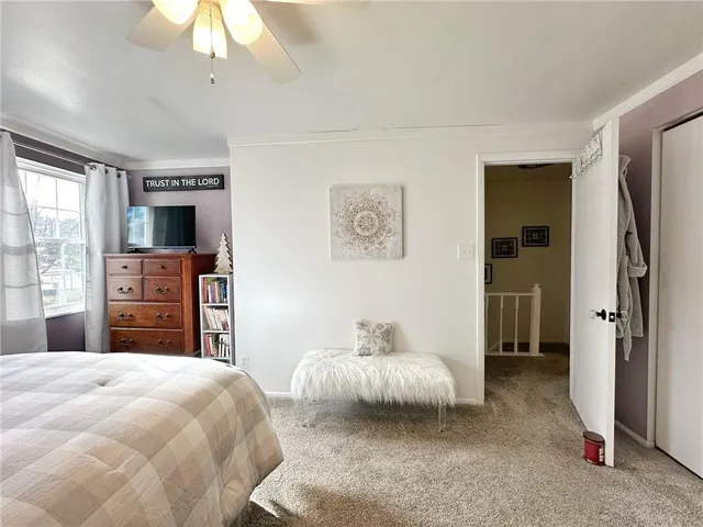 a bedroom with a large bed and a chandelier