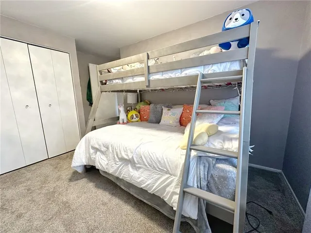 a bed sitting in a bedroom next to a window