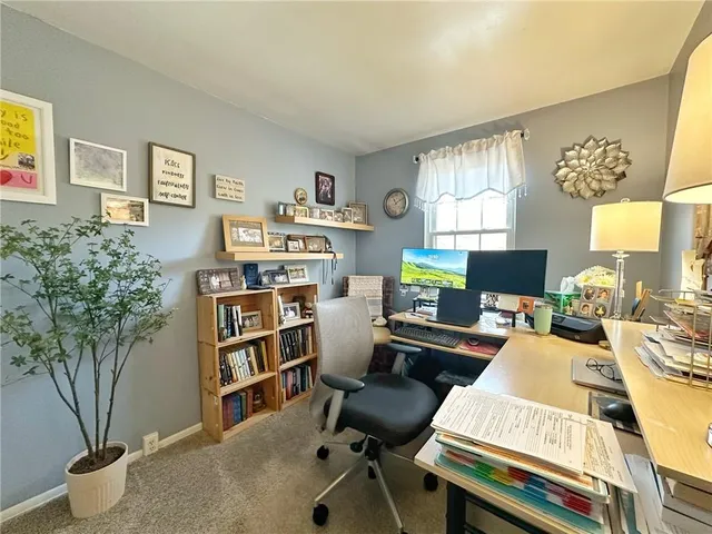 a view of a workspace with a window and lounge chair
