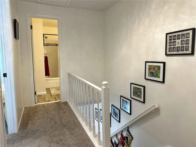 a view of a hallway with paintings on the wall