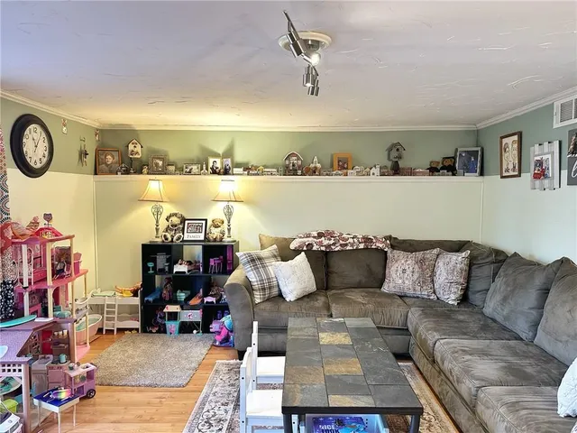 a living room with furniture and a floor to ceiling window