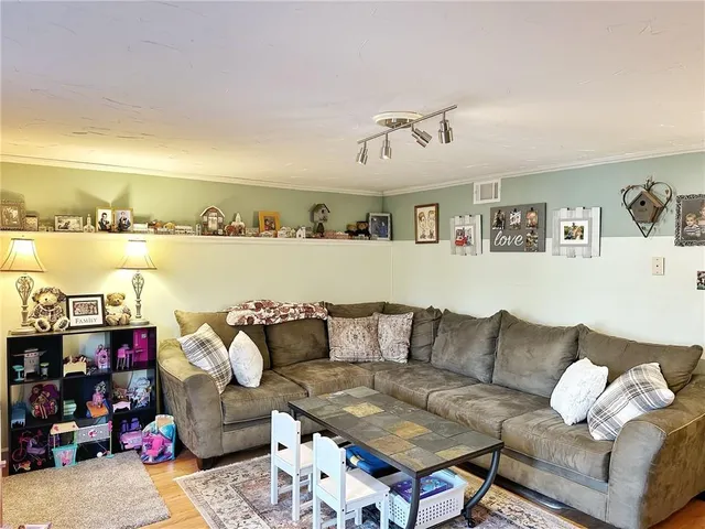 a living room with furniture and kitchen view