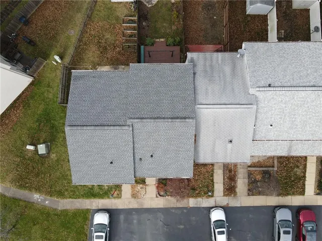an aerial view of a house with a yard