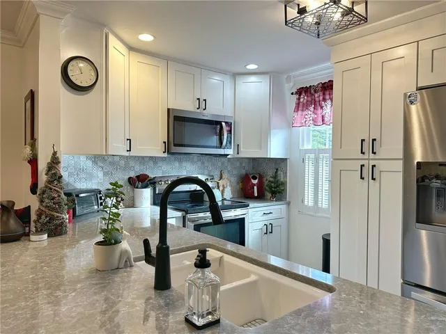 a kitchen with a refrigerator and a sink