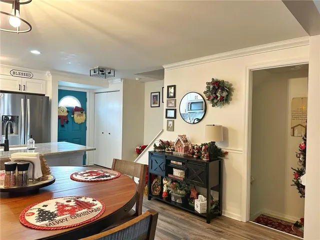 a dining room with furniture and wooden floor