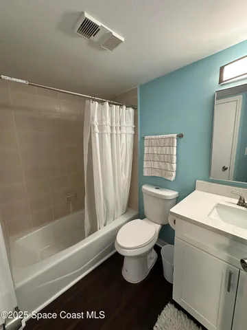a bathroom with a sink a toilet a mirror and a bathtub