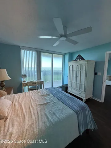 a bed sitting in a spacious bedroom next to a window