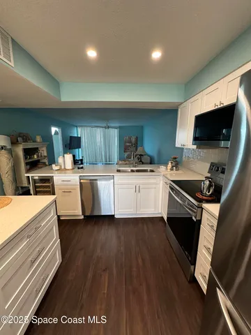 a kitchen with a sink stainless steel appliances and cabinets
