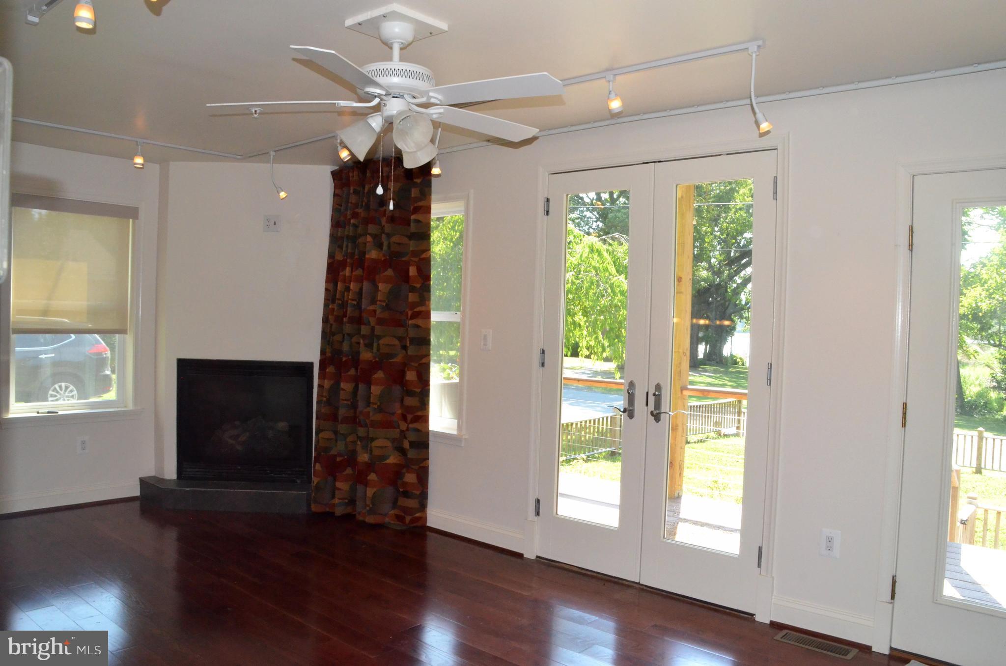 7370 Station Road Newcomb, MD 21653 - Photo 12 of 30 a view of an empty room with wooden floor and a window