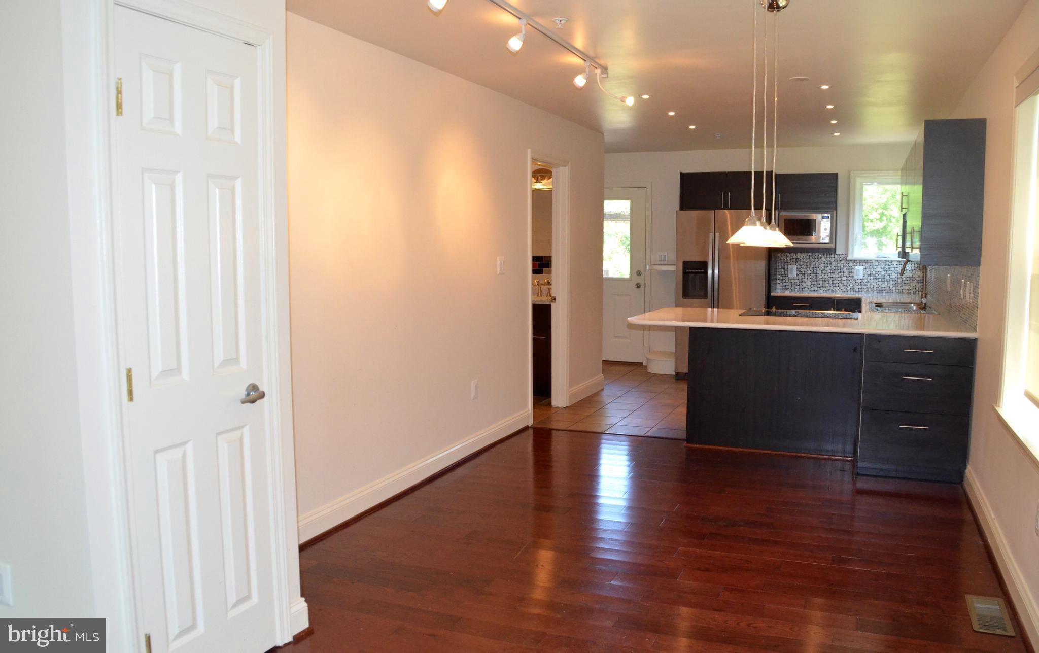 7370 Station Road Newcomb, MD 21653 - Photo 8 of 30 an open kitchen with a table and chairs in it