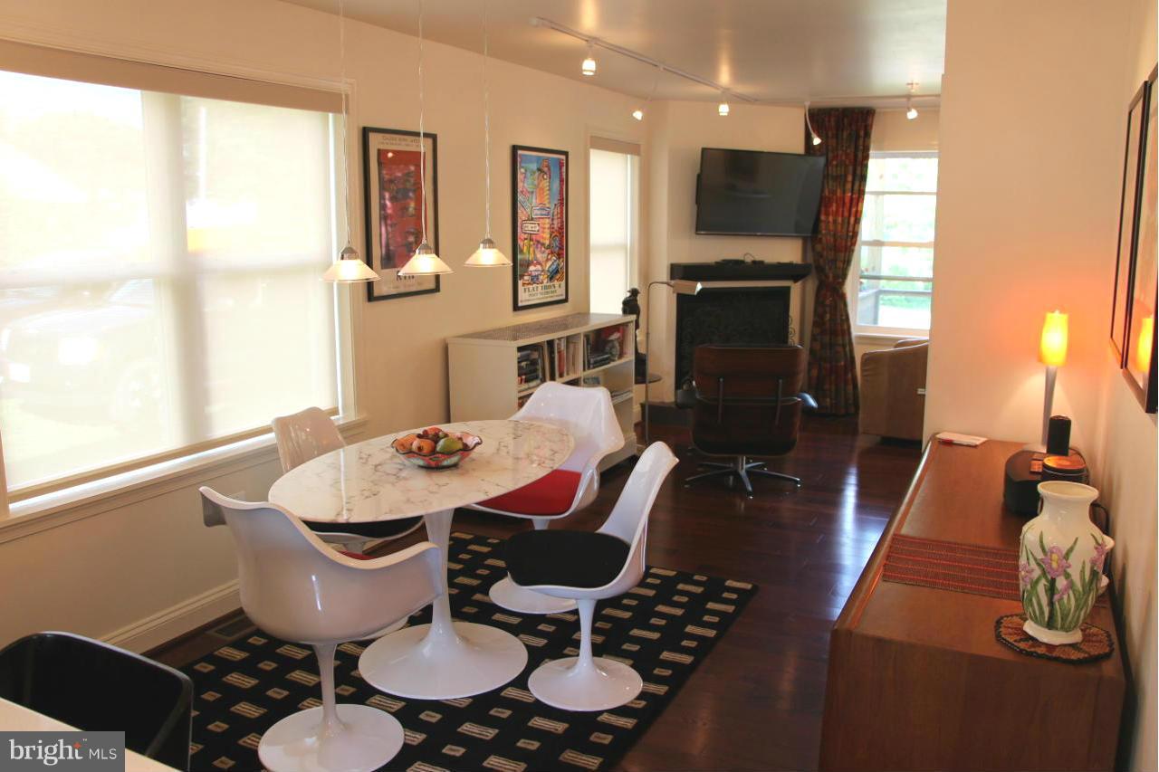 7370 Station Road Newcomb, MD 21653 - Photo 9 of 30 a dinning room with furniture a fireplace and wooden floor