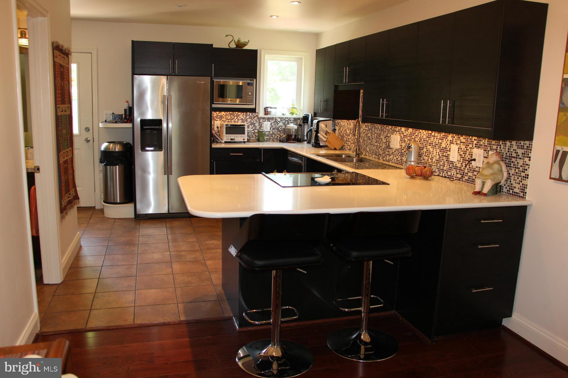 7370 Station Road Newcomb, MD 21653 - Photo 10 of 30 a kitchen with a sink and refrigerator