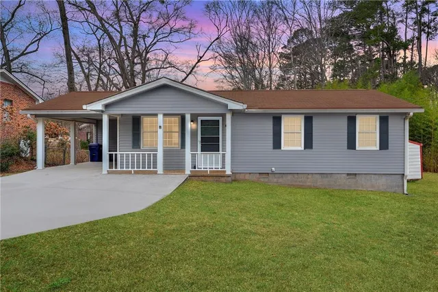 a front view of a house with yard and green space