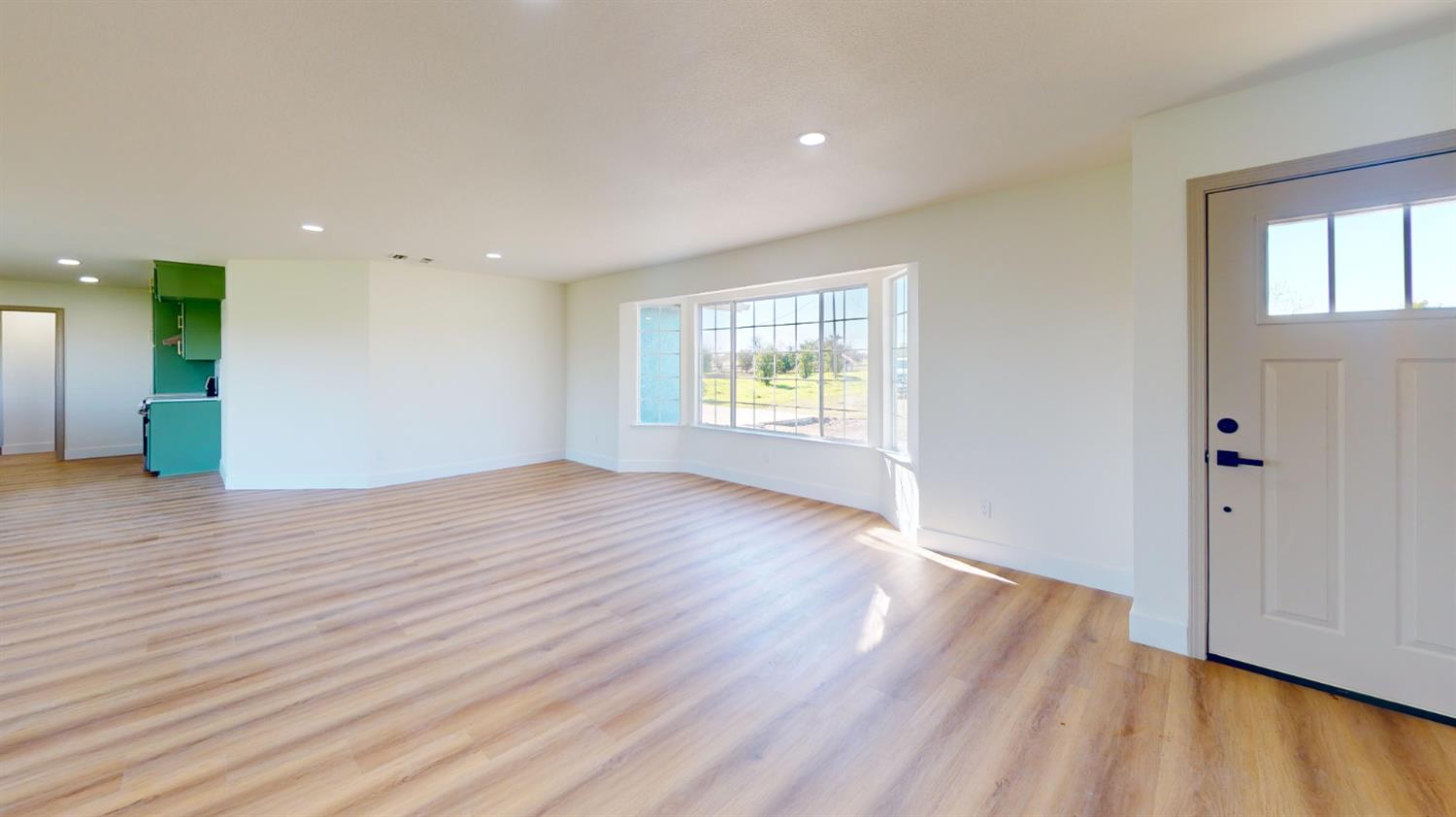 16363 Paula Road Madera, CA 93636 - Photo 11 of 29 an empty room with wooden floor and windows