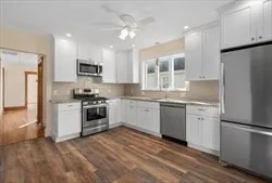 a kitchen with a refrigerator stove top oven and sink