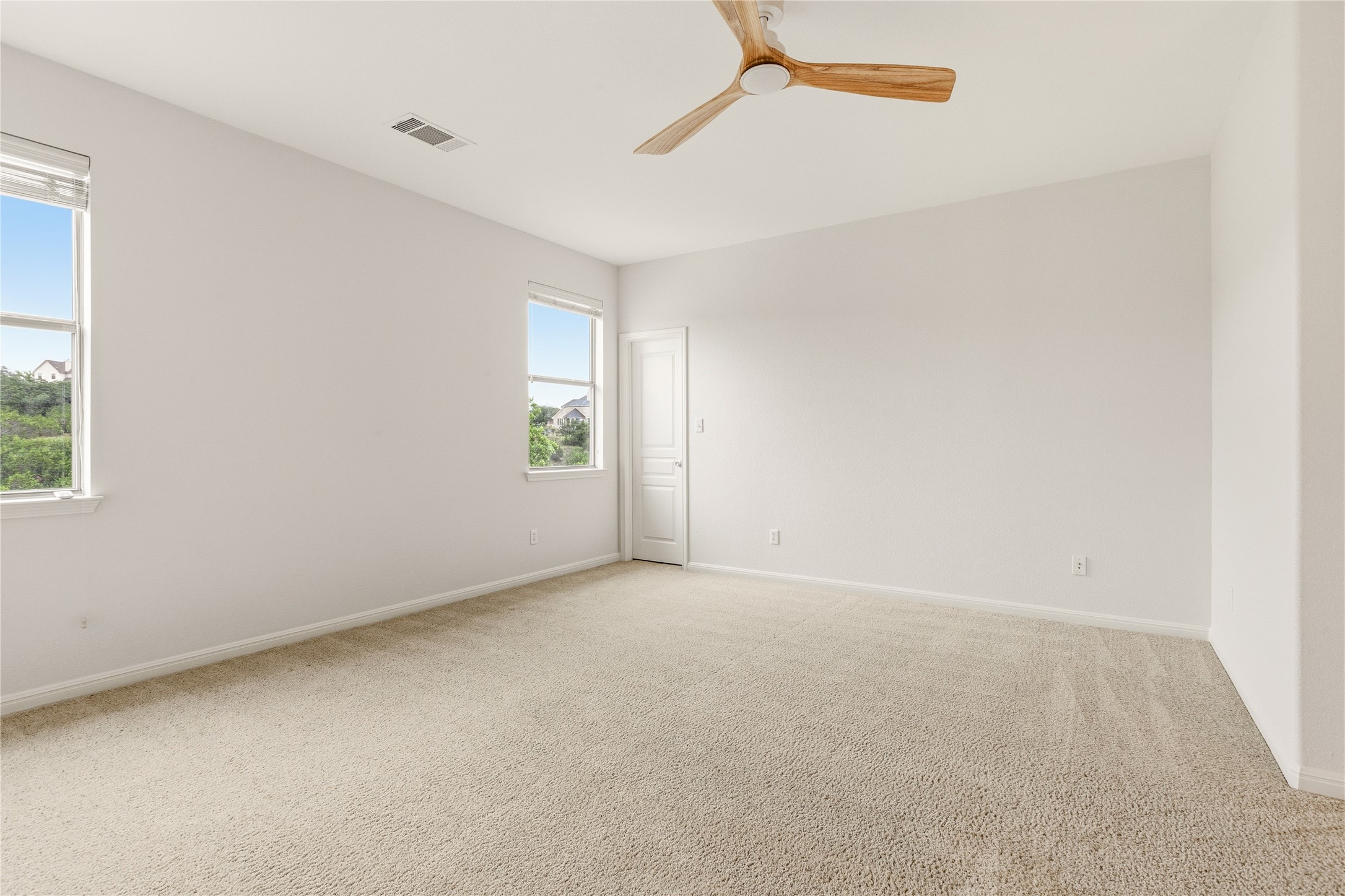 1432 Tom Sawyer Road Austin, TX 78737 - Photo 22 of 33 A quiet, well-lit bedroom featuring ample natural light and a modern ceiling fan.