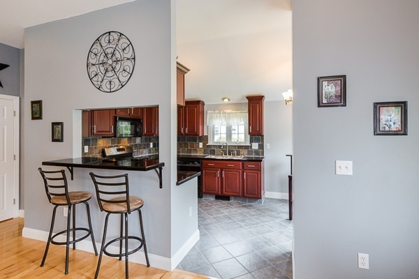 72 Ferry Road Salisbury, MA 01952 - Photo 5 of 30 a view of a kitchen with granite countertop a stove a oven a dining table and chairs