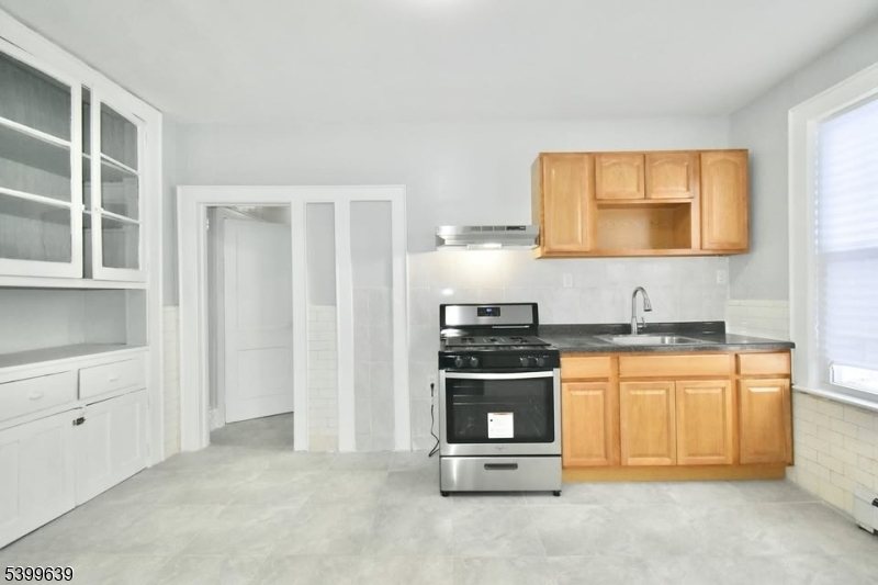 519 Clinton Place, Unit 2R Newark, NJ 07112 - Photo 11 of 14 a kitchen with stainless steel appliances granite countertop a stove and a refrigerator