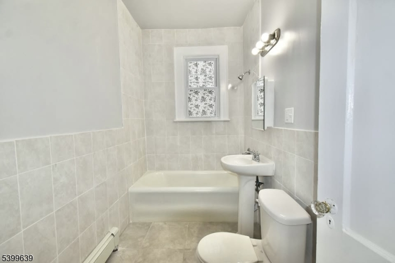 519 Clinton Place, Unit 2R Newark, NJ 07112 - Photo 8 of 14 a bathroom with a sink and bathtub