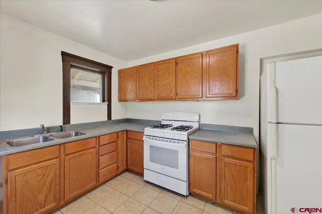 a kitchen with a sink stove and refrigerator