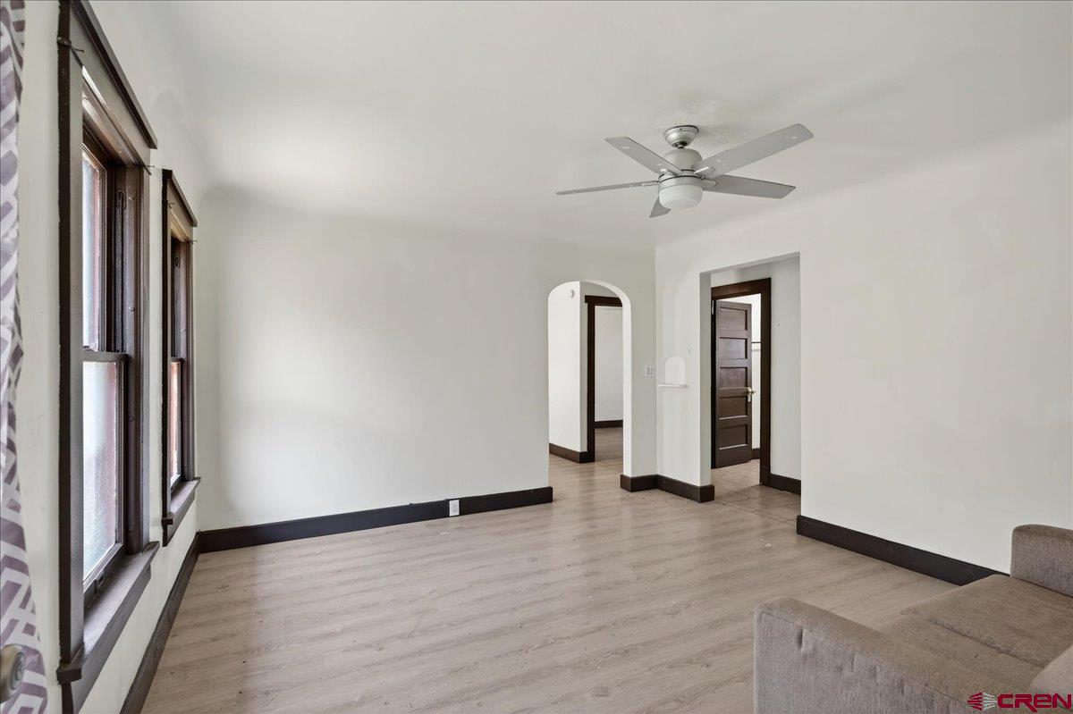 2091 Locust Road Montrose, CO 81401 - Photo 27 of 45 an empty room with wooden floor and a ceiling fan
