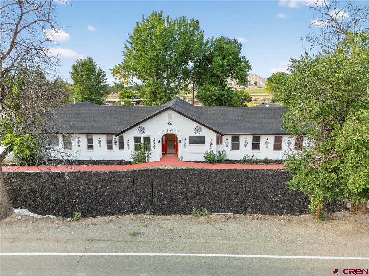 2091 Locust Road Montrose, CO 81401 - Photo 29 of 45 a front view of a house with a yard and garage