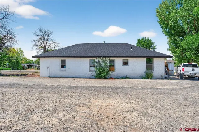 a front view of house with yard and trees