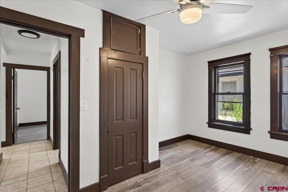 2091 Locust Road Montrose, CO 81401 - Photo 5 of 45 a view of an empty room with window and wooden floor