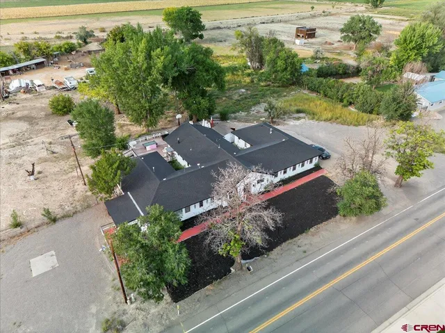 an aerial view of a house with a yard