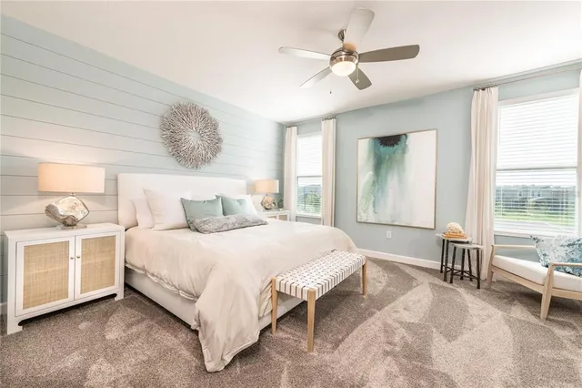 a spacious bedroom with a large bed and a chandelier