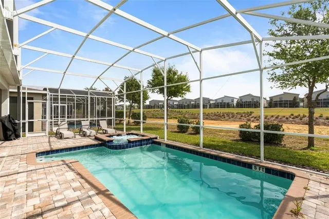 a view of a swimming pool with a yard