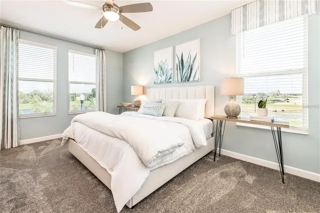 a bedroom with a bed and large window