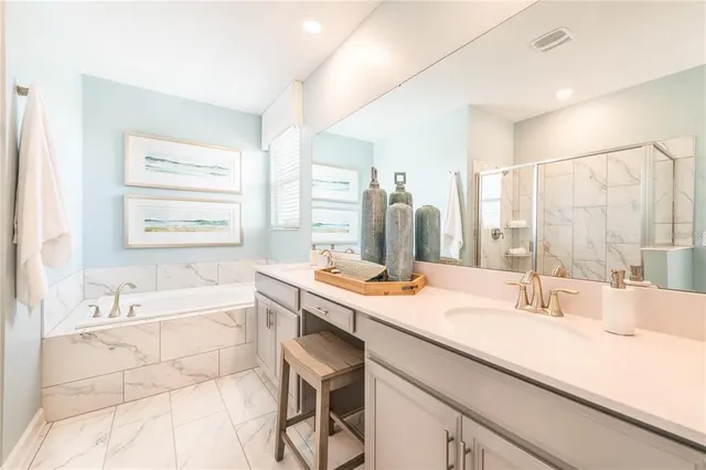 a bathroom with a tub sink and mirror