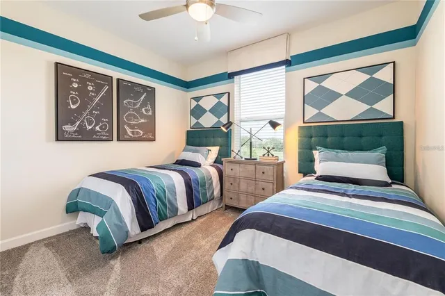 a bedroom with two beds and a large window