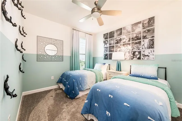 a bedroom with two beds and painted walls