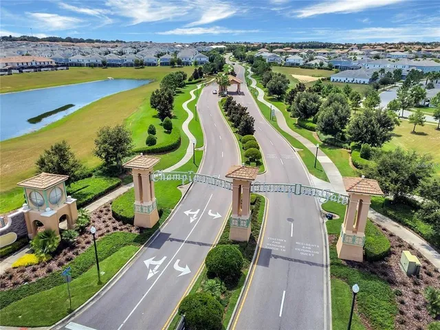 an aerial view of a house with a garden and lake view