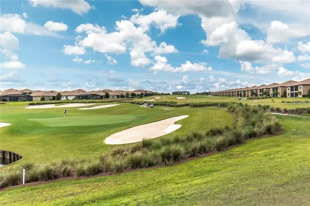 a view of a lake with houses in back