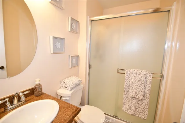 a bathroom with a sink mirror vanity and toilet