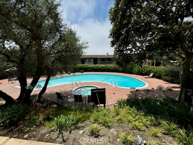 a view of a swimming pool and trees in the background