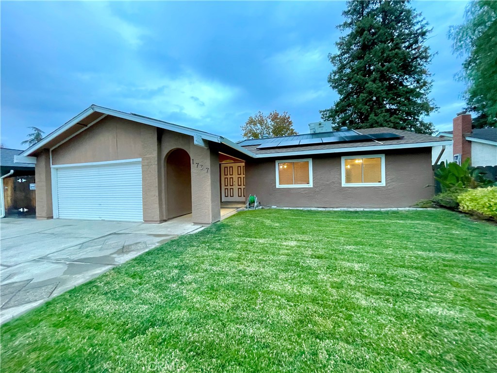 1737 Shady Hollow Court Merced, CA 95340 - Photo 1 of 1 a front view of house with yard and trees in the background