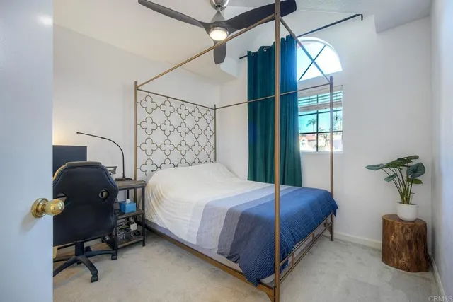 a bedroom with a bed and a window